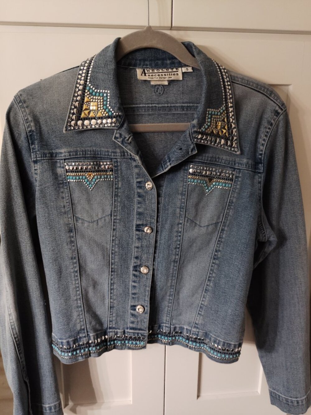 A Vintage Western Themed Jean Jacket detailed with silver, gold and turquoise